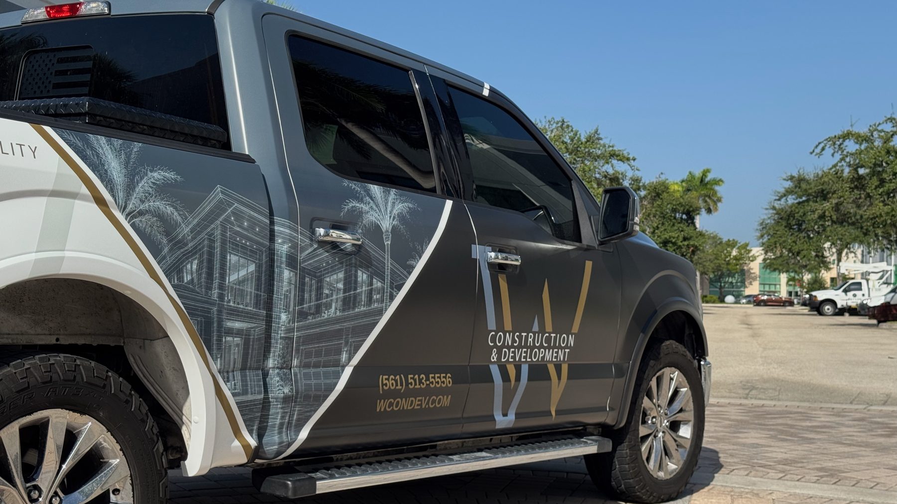 Architectural imagery and premium branding detail on W Construction & Development truck wrap