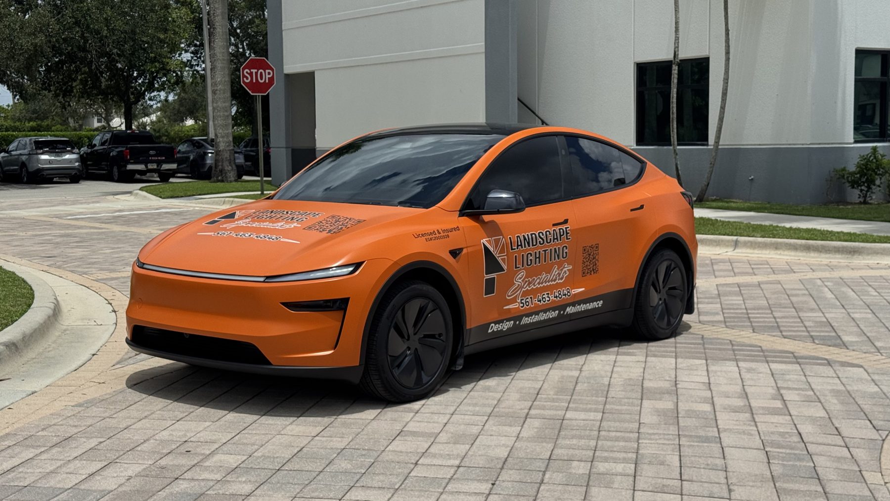 Front view of custom Tesla Model Y business wrap for Landscape Lighting Specialists