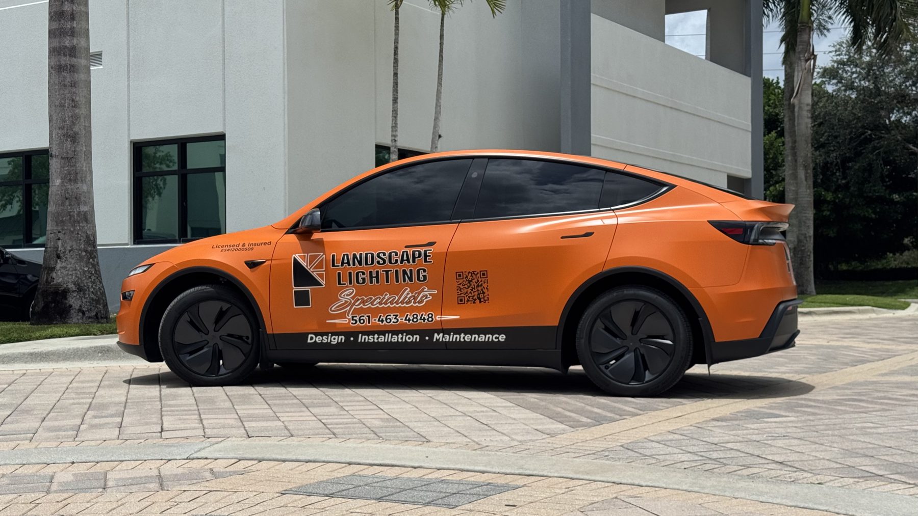 Landscape Lighting Specialists orange Tesla Model Y commercial fleet wrap in Palm Beach County