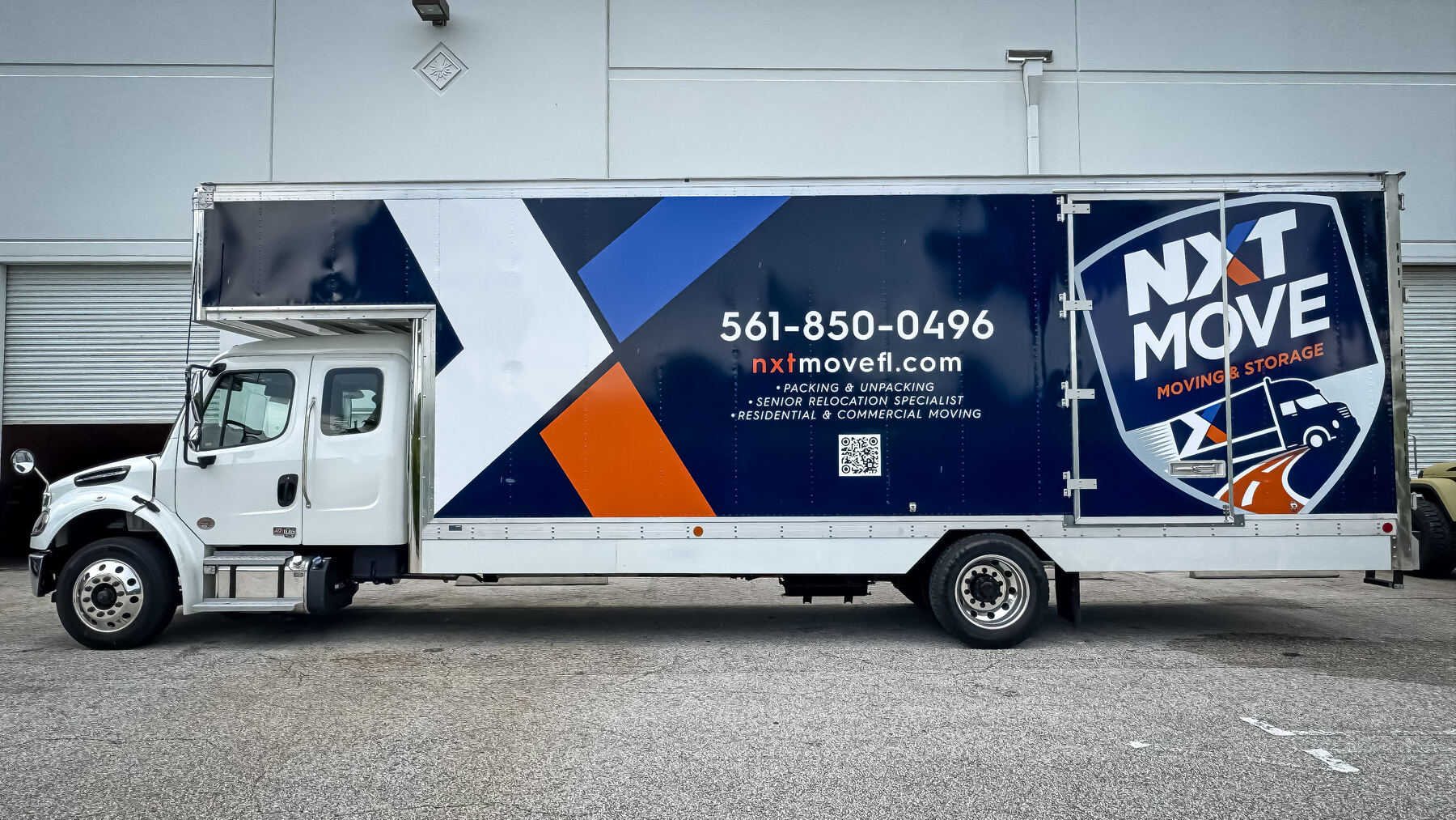 After: opposite side of the NXT Move 26-foot box truck with logo, phone number, website and service graphics