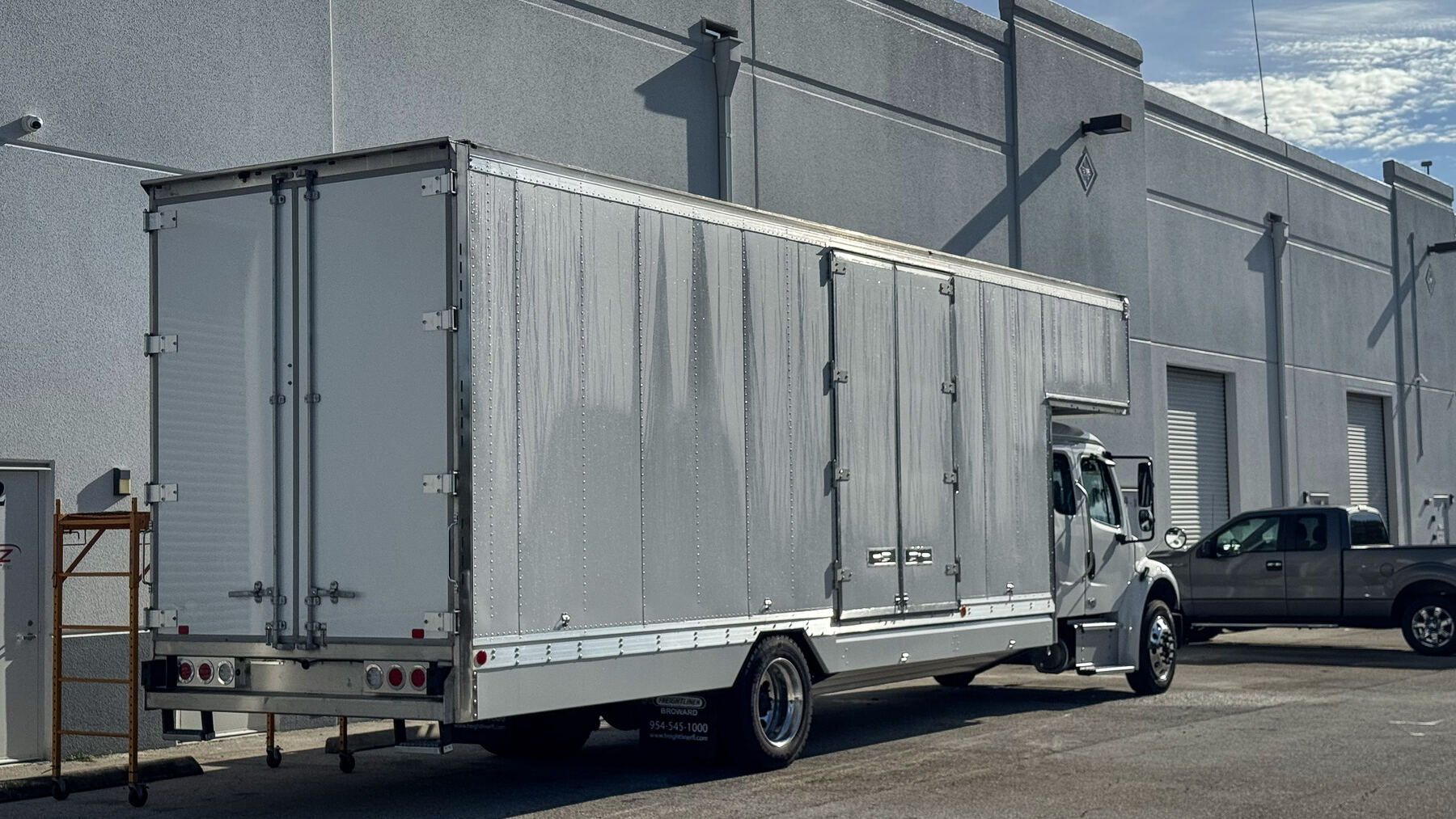 Rear and side of the blank 26-foot commercial box truck before NXT Move graphics were installed