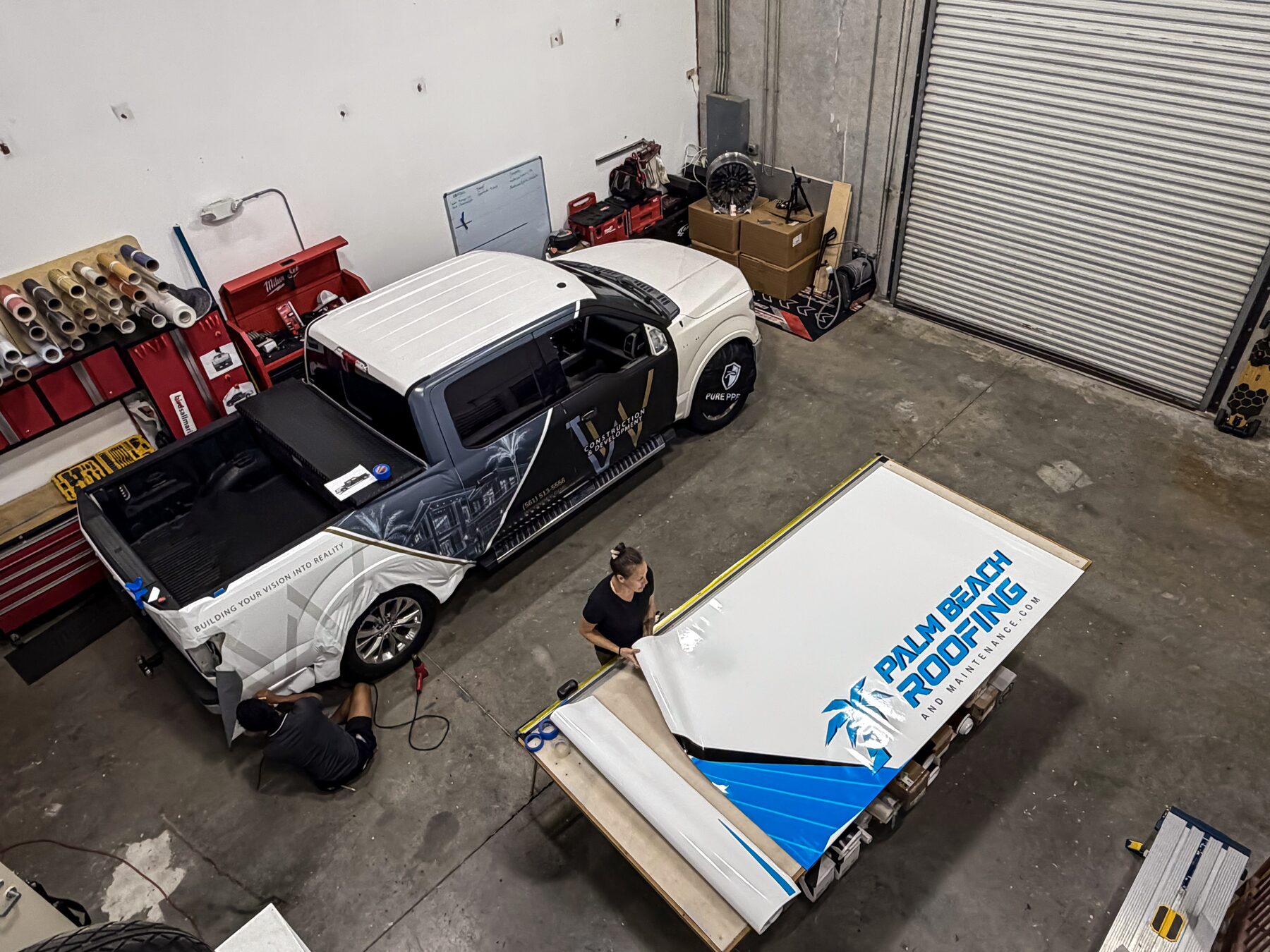 Palm Beach Roofing fleet graphics being prepared at the CRD Wraps production facility