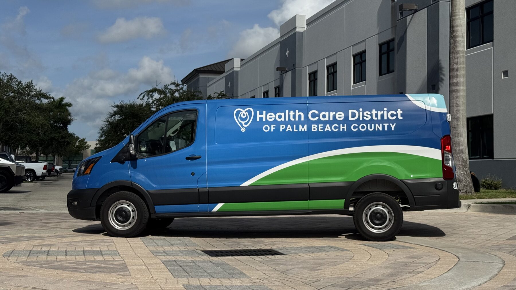 Low-roof Ford Transit with Health Care District of Palm Beach County fleet graphics