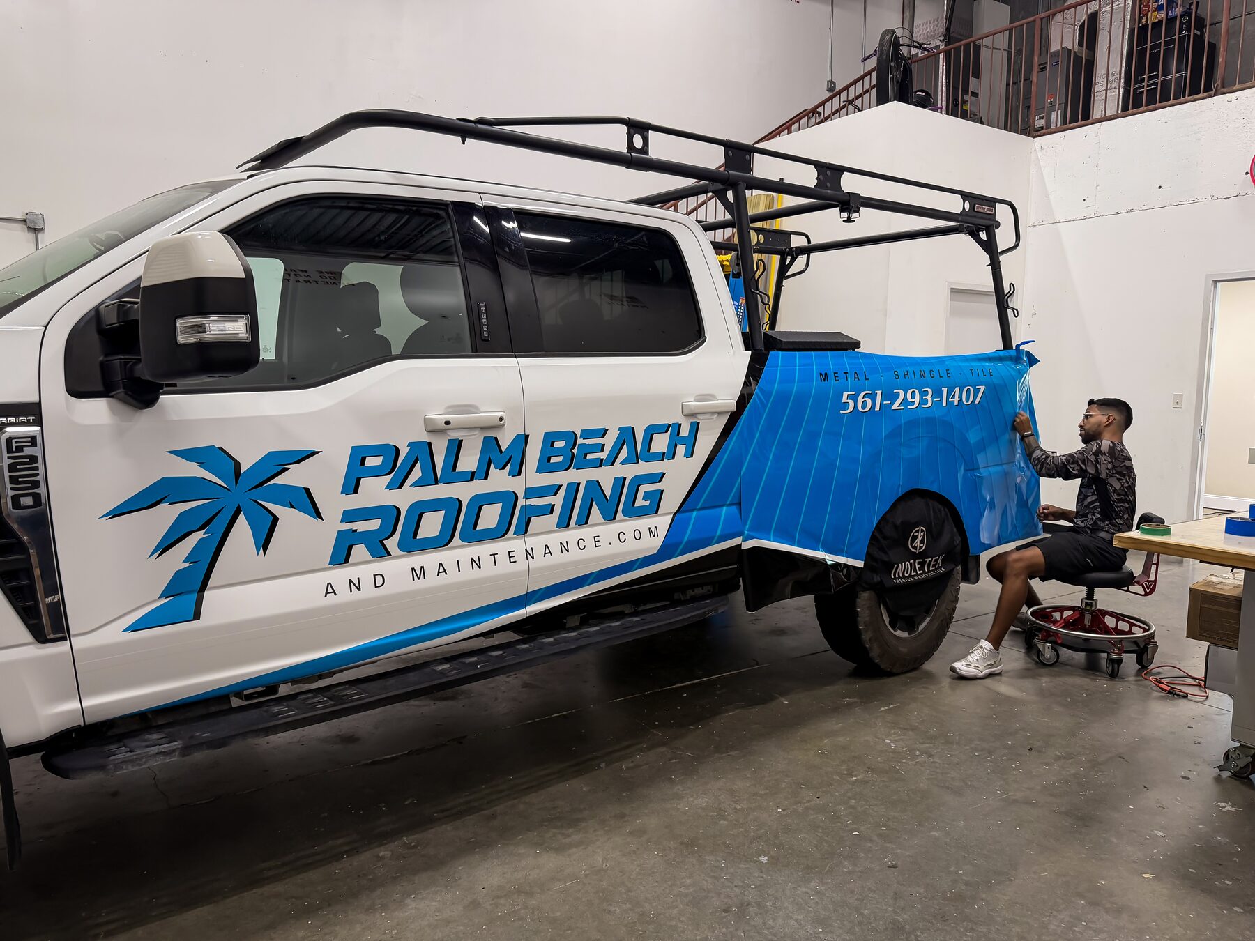 Roofing truck wrap installation on a Ford F-Series truck at CRD Wraps